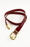 Red braided belt with a gold buckle on a white background