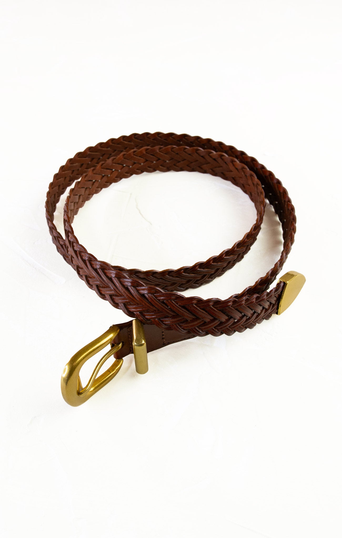 Brown braided belt with a gold buckle on a white background