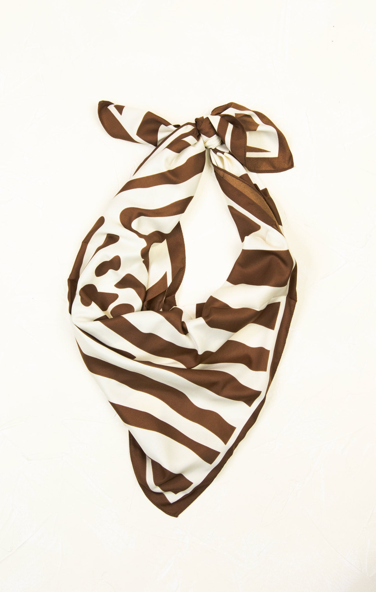 Brown and white zebra print scarf on a white background