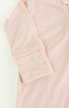 Close-up of a light pink hoodie with a pocket on a white background