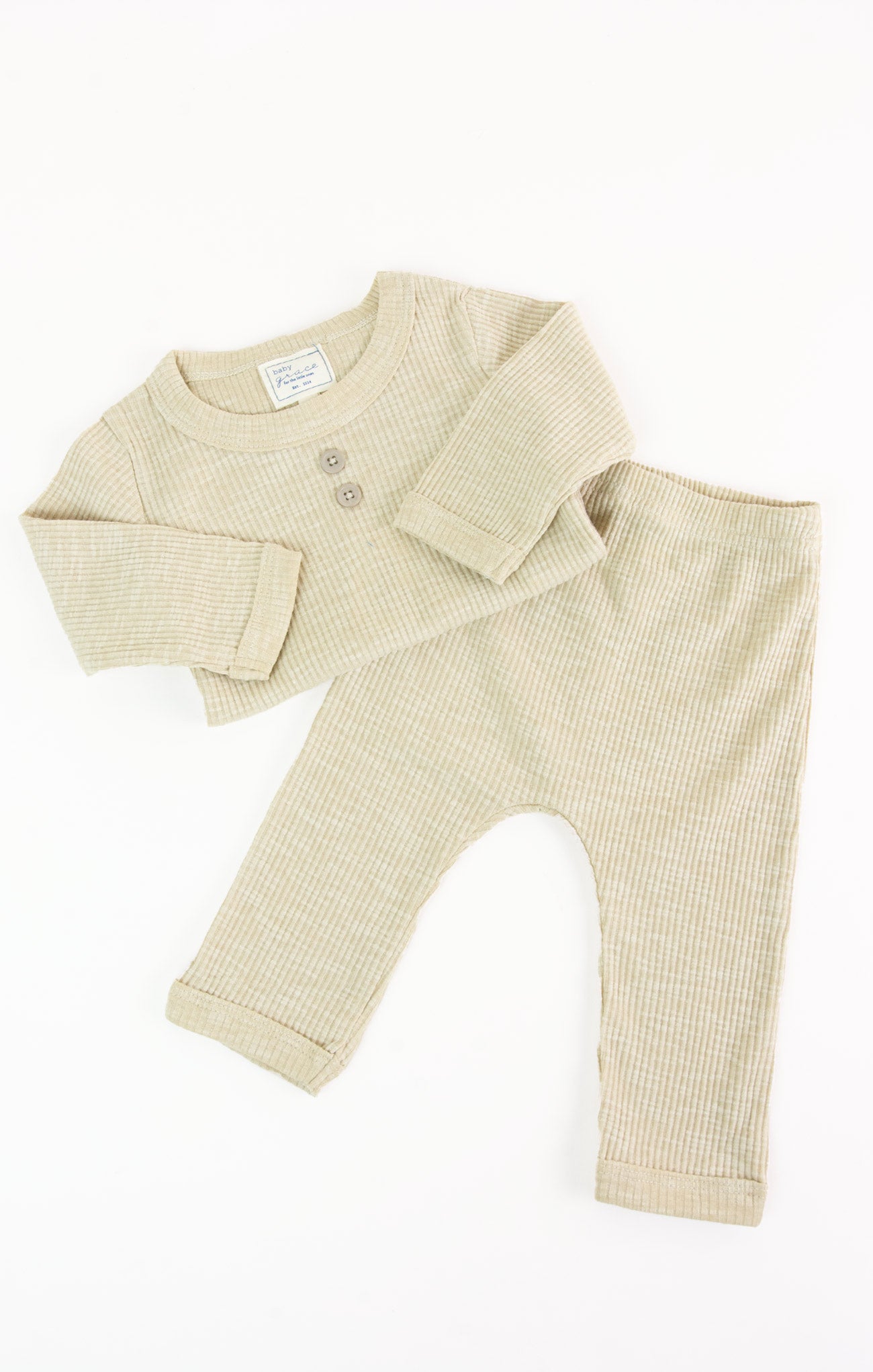 Beige baby outfit with shirt and pants on a white background