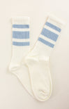 White socks with blue stripes on a light beige background