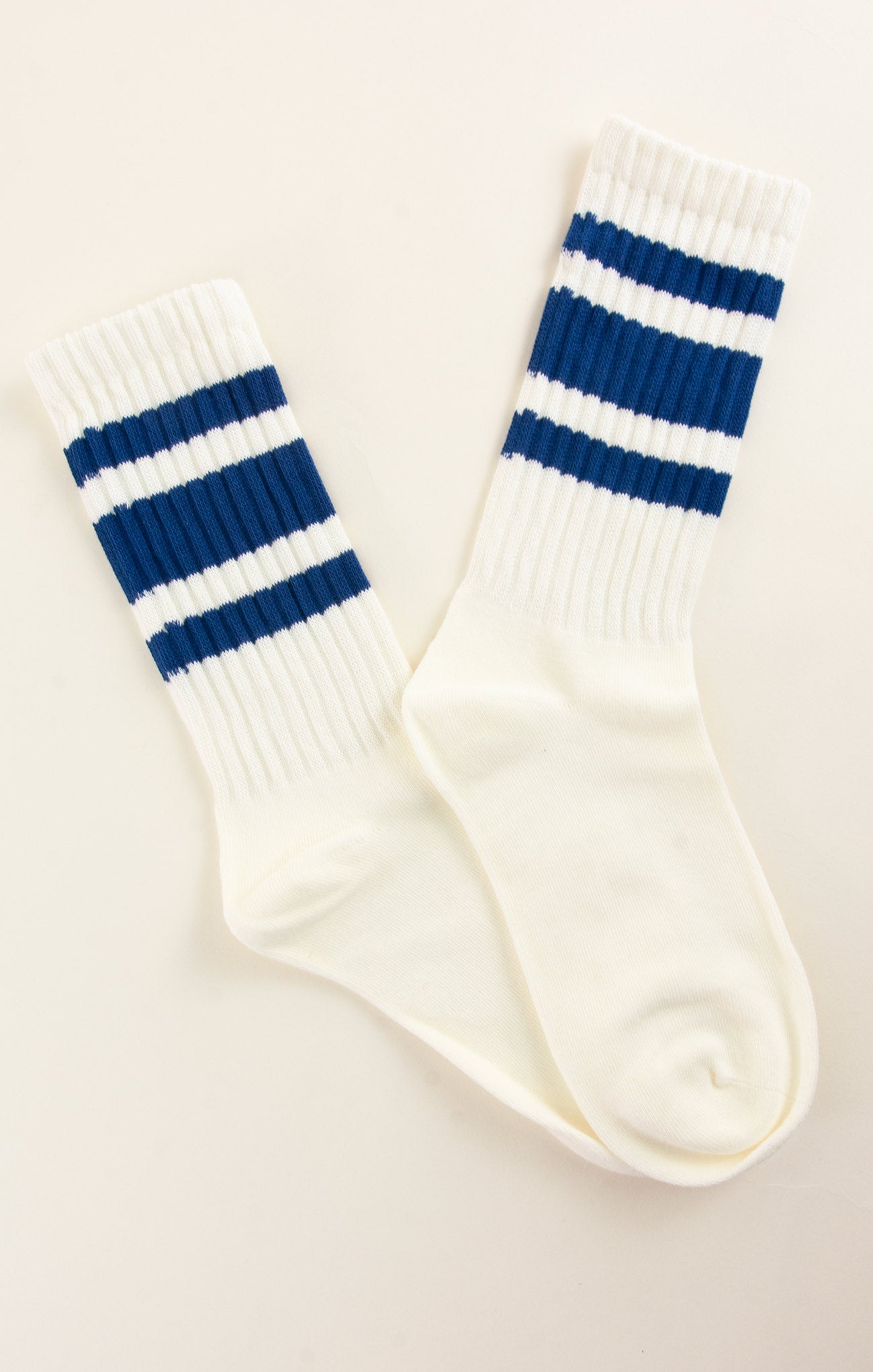 White socks with blue stripes on a beige background