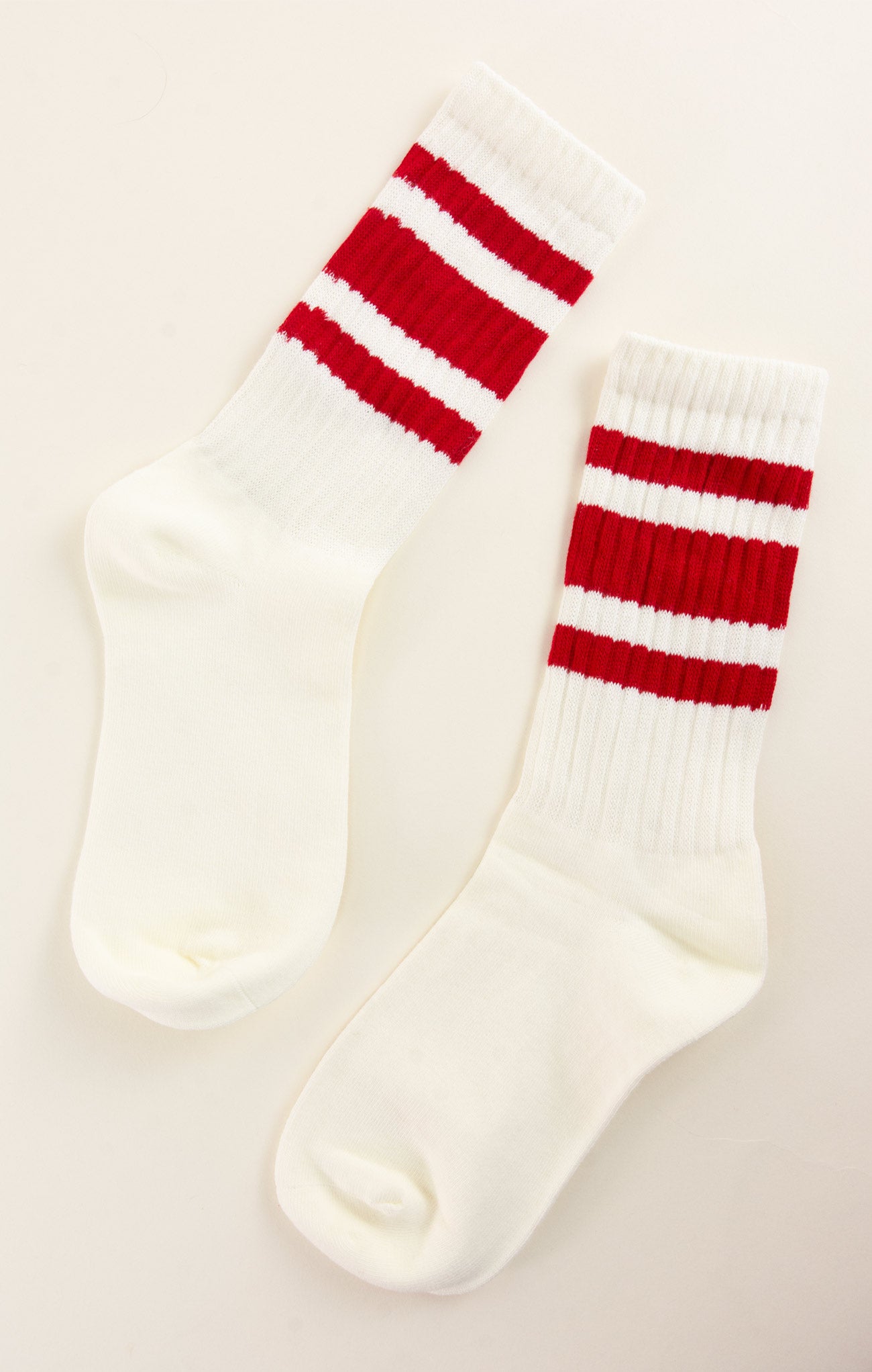 White socks with red stripes on a light gray background
