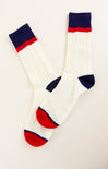 White socks with red and blue accents on a light beige background