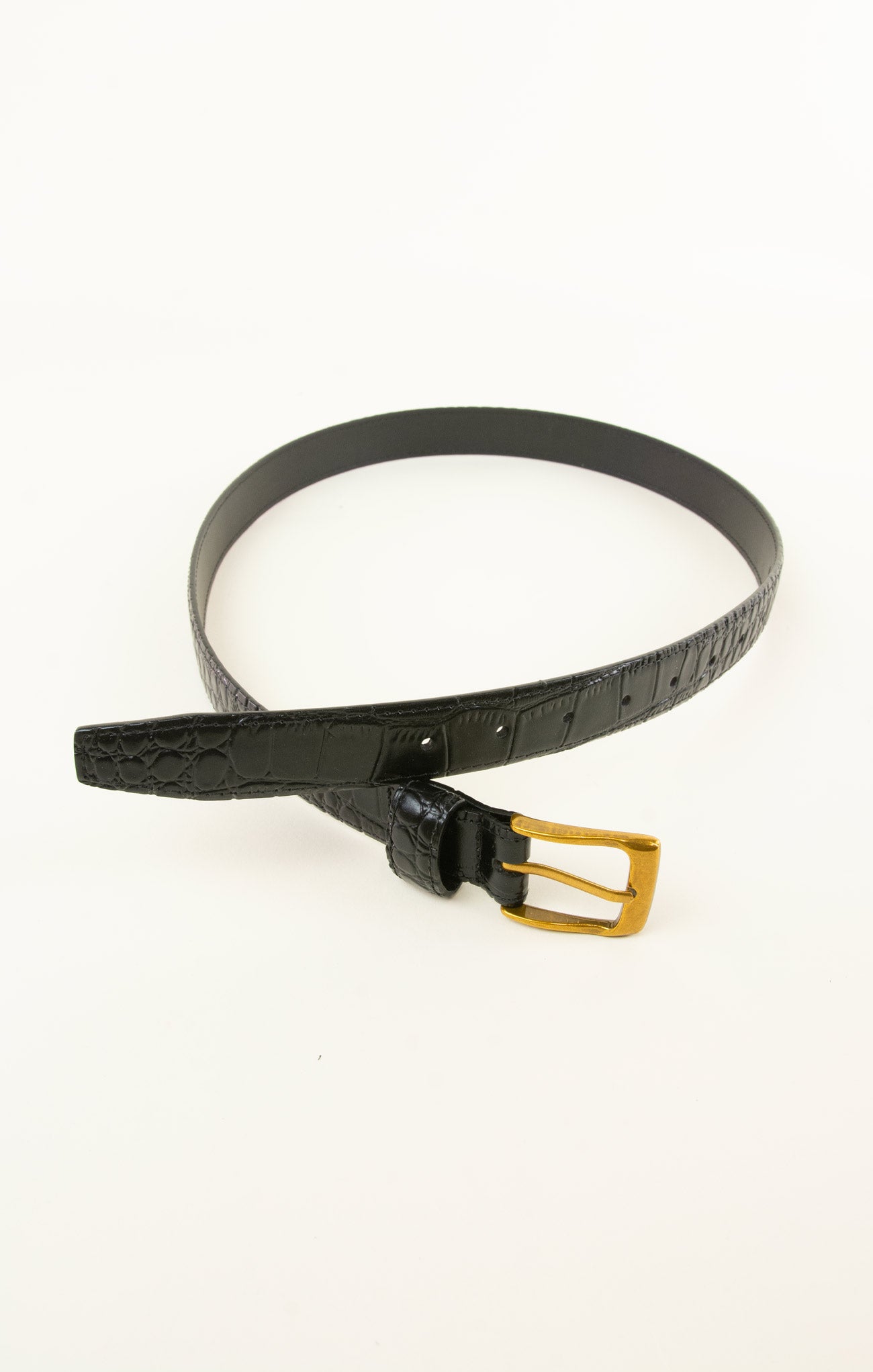 Black belt with a gold buckle on a white background