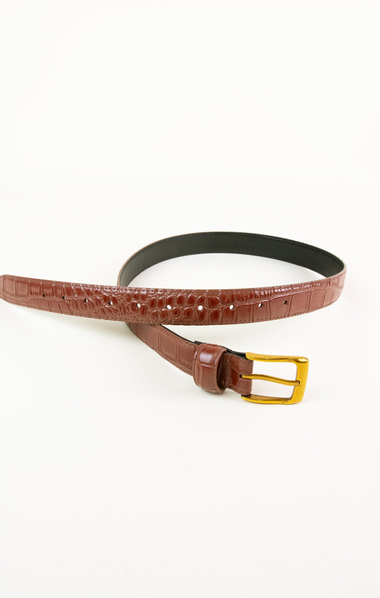 Brown belt with a gold buckle on a white background