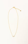 Gold necklace with small pearls on a white background