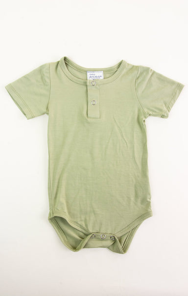 Green baby onesie on a white background
