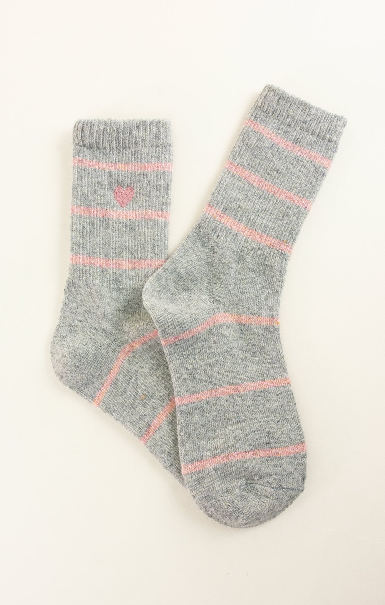 Pair of gray socks with pink stripes on a white background