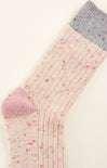 Colorful sock with pink toe and heel on a light background