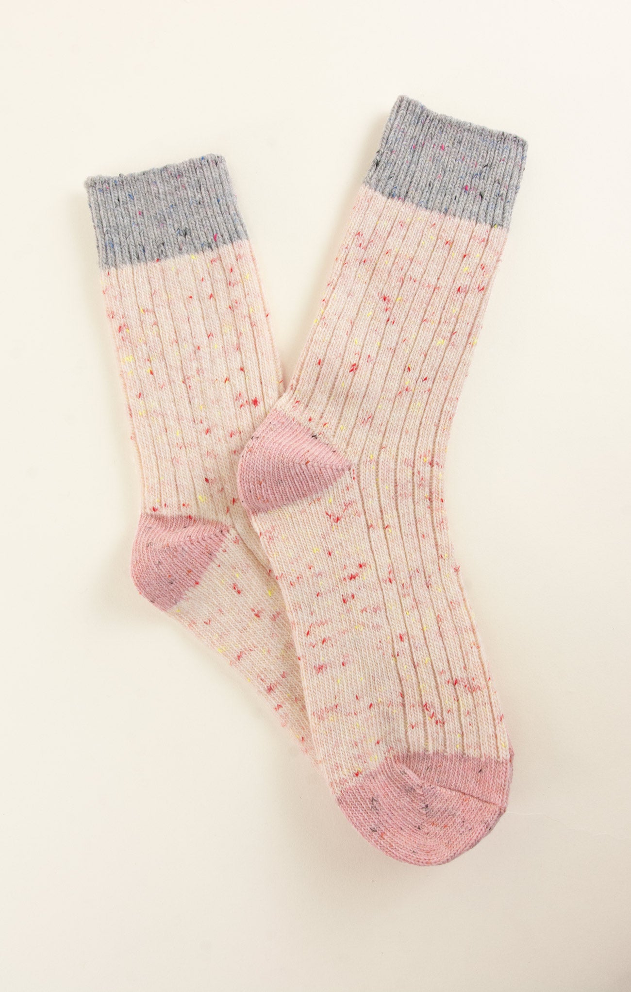 Pair of pink socks with gray cuffs on a white background