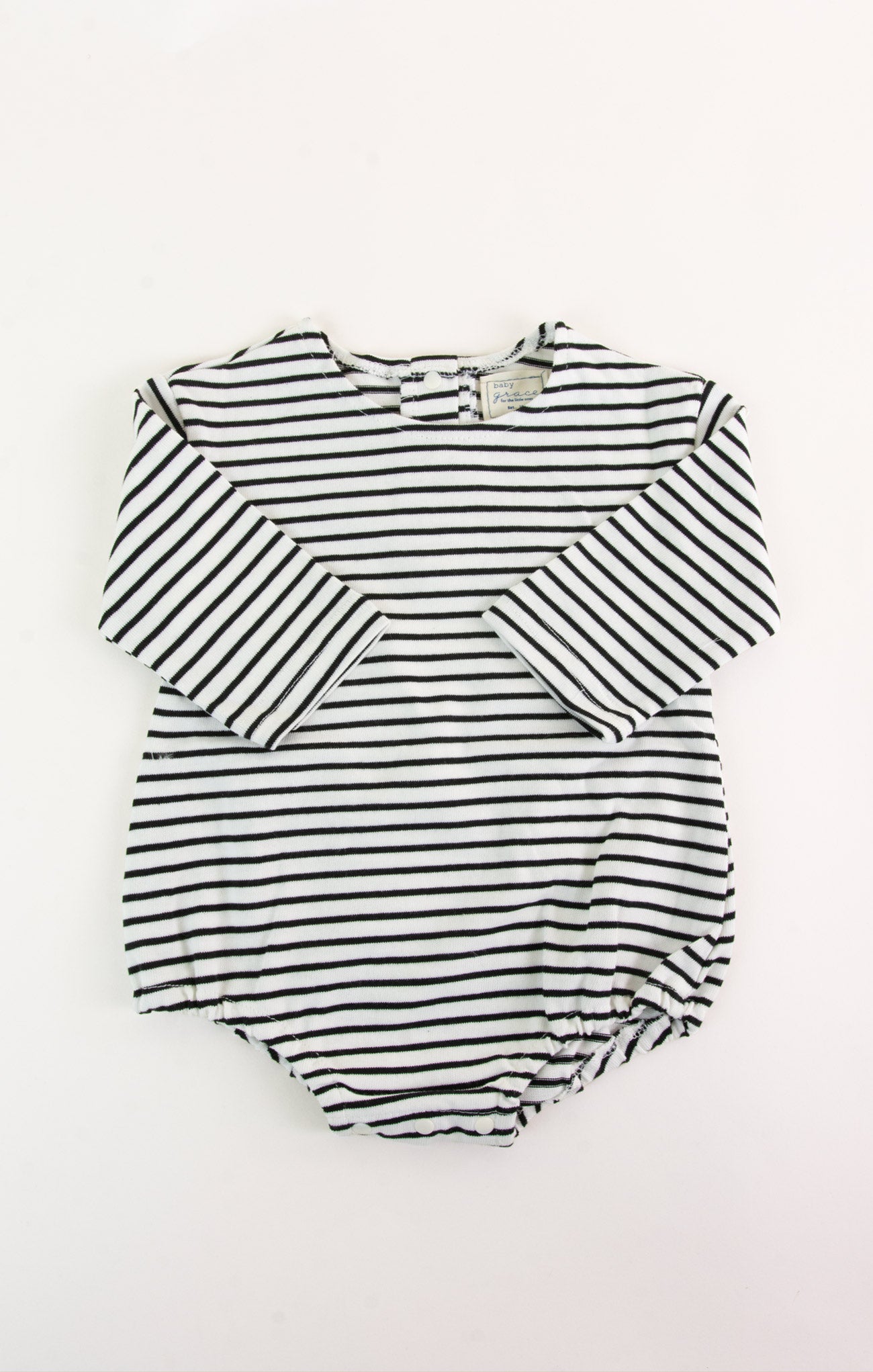 Black and white striped baby romper on a white background