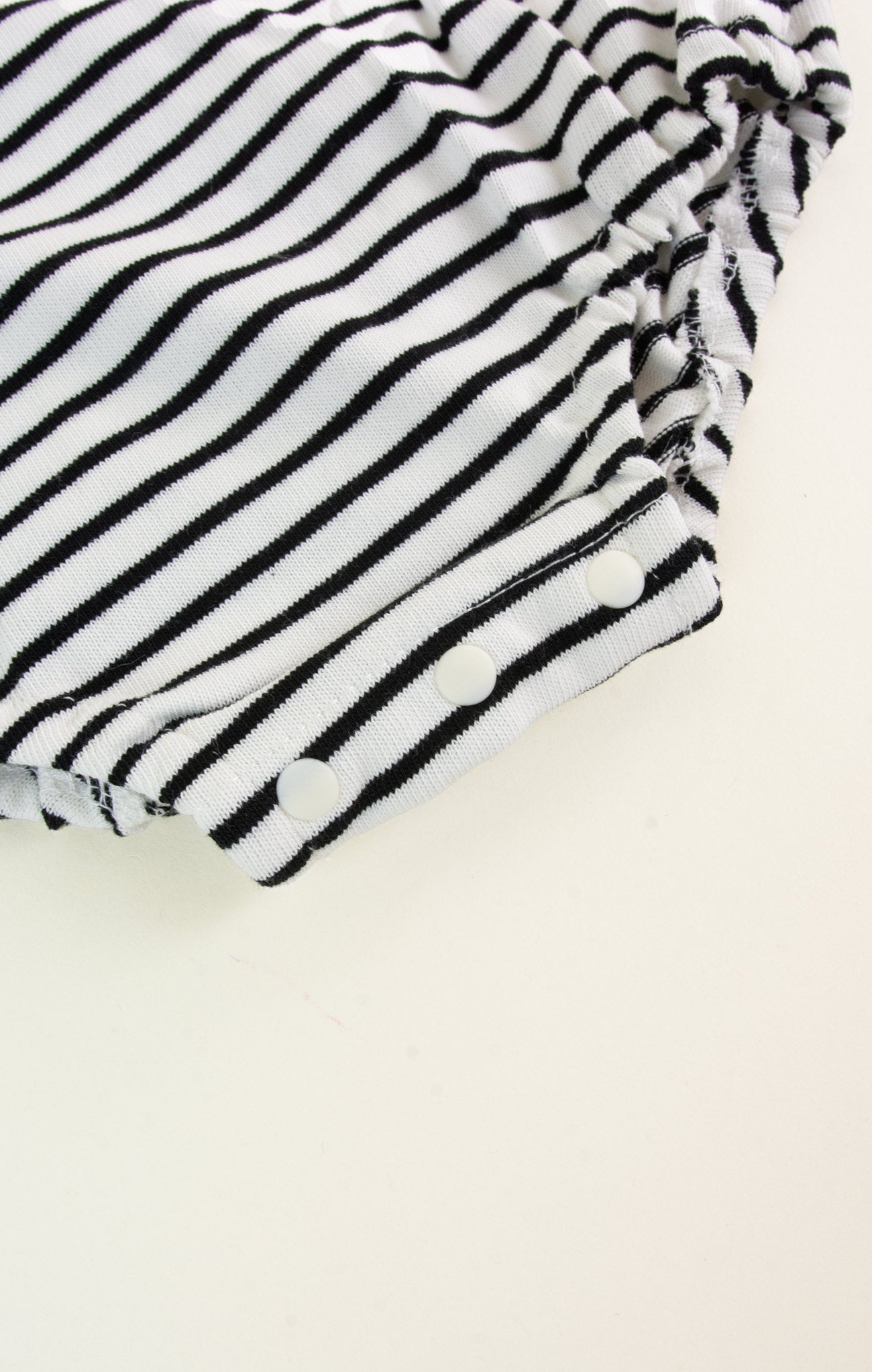 Black and white striped fabric on a beige background