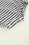 Black and white striped fabric on a beige background