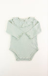 Light green baby romper with ruffled collar on a white background