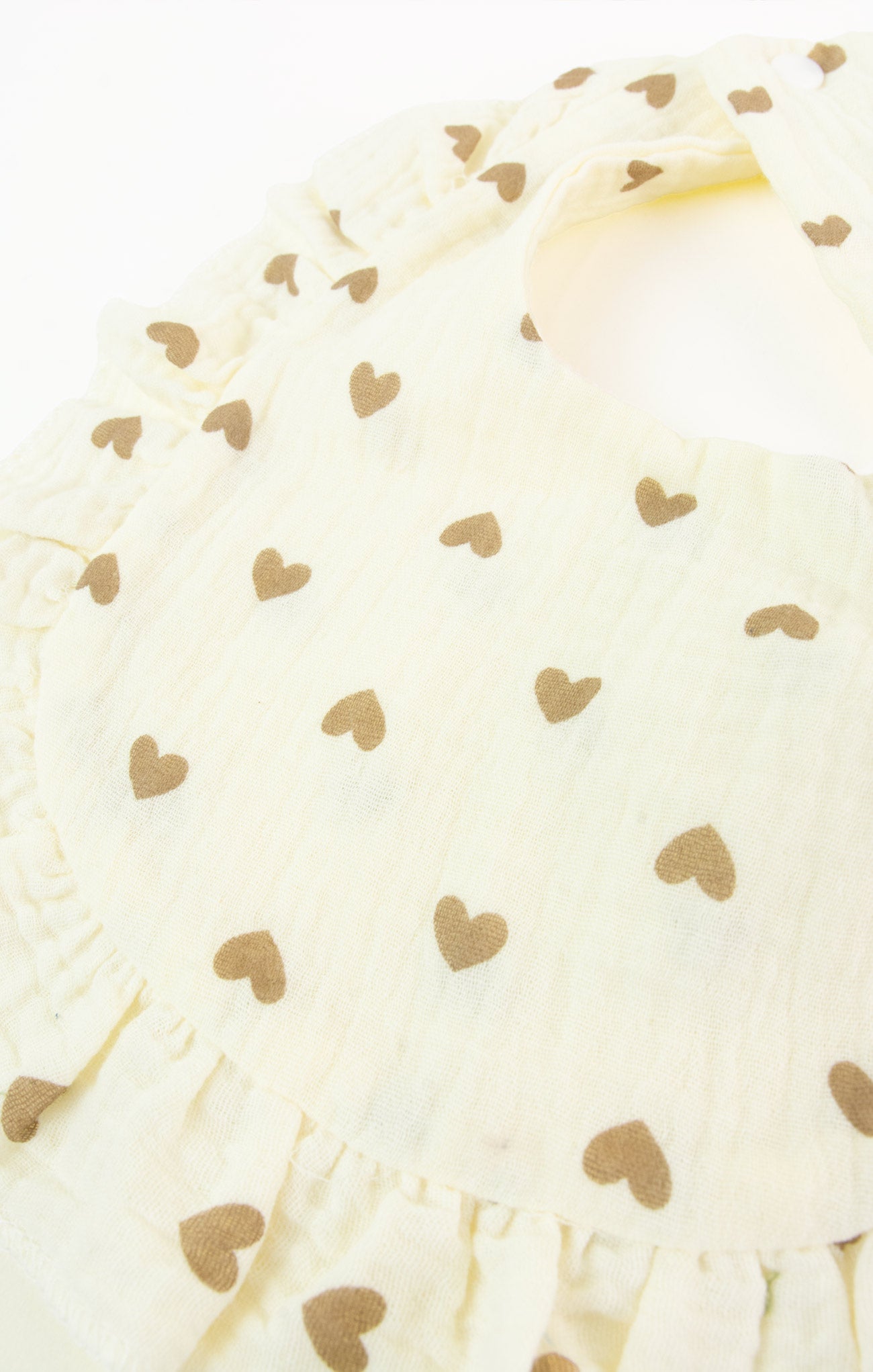 Close-up of a white fabric with gold heart patterns