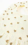 Close-up of a white fabric with gold heart patterns