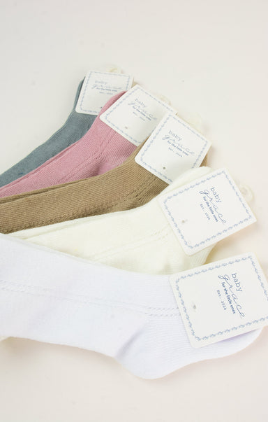 Set of women's underwear with tags on a light background