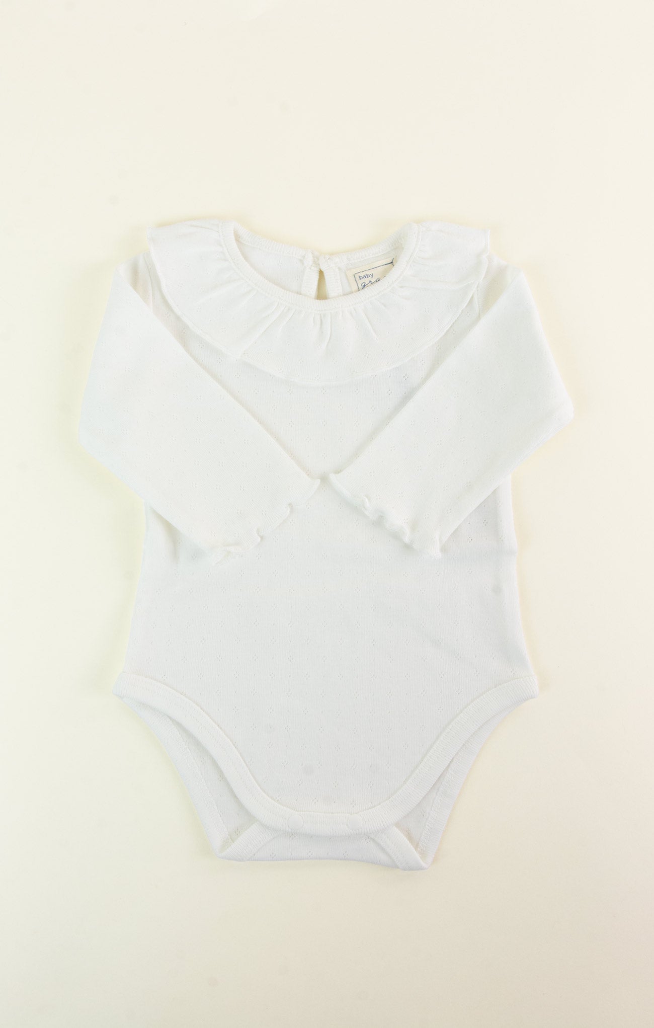 Light blue bodysuit on a beige background