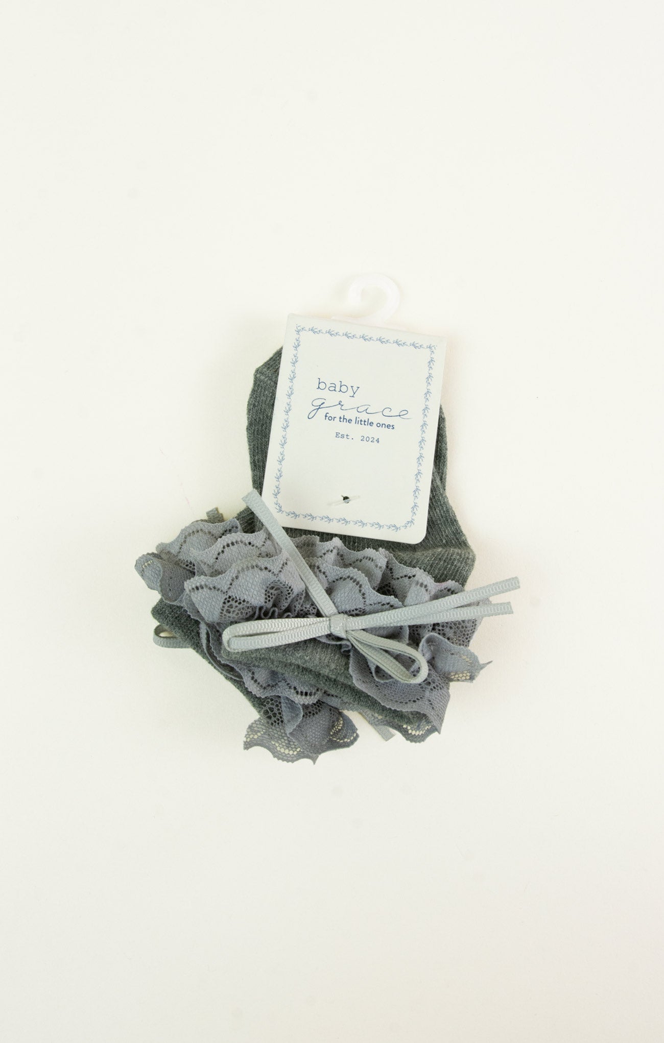 Gray baby booties with a matching headband on a white background