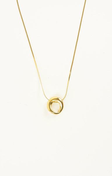 Gold necklace with a circular pendant on a white background