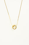 Gold necklace with a circular pendant on a white background