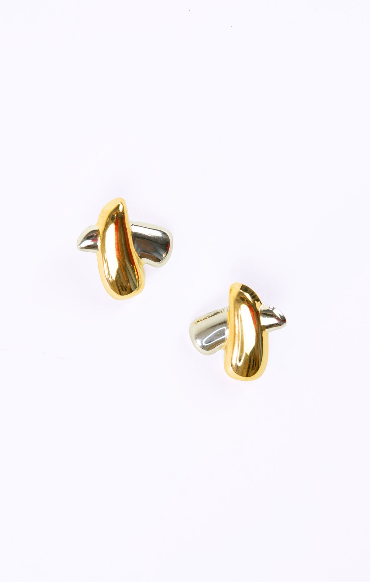 Gold and silver cufflinks on a white background