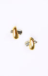 Gold and silver cufflinks on a white background