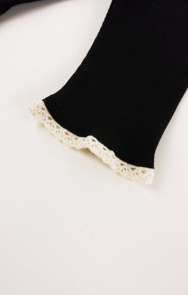 Black sock with lace trim on a white background