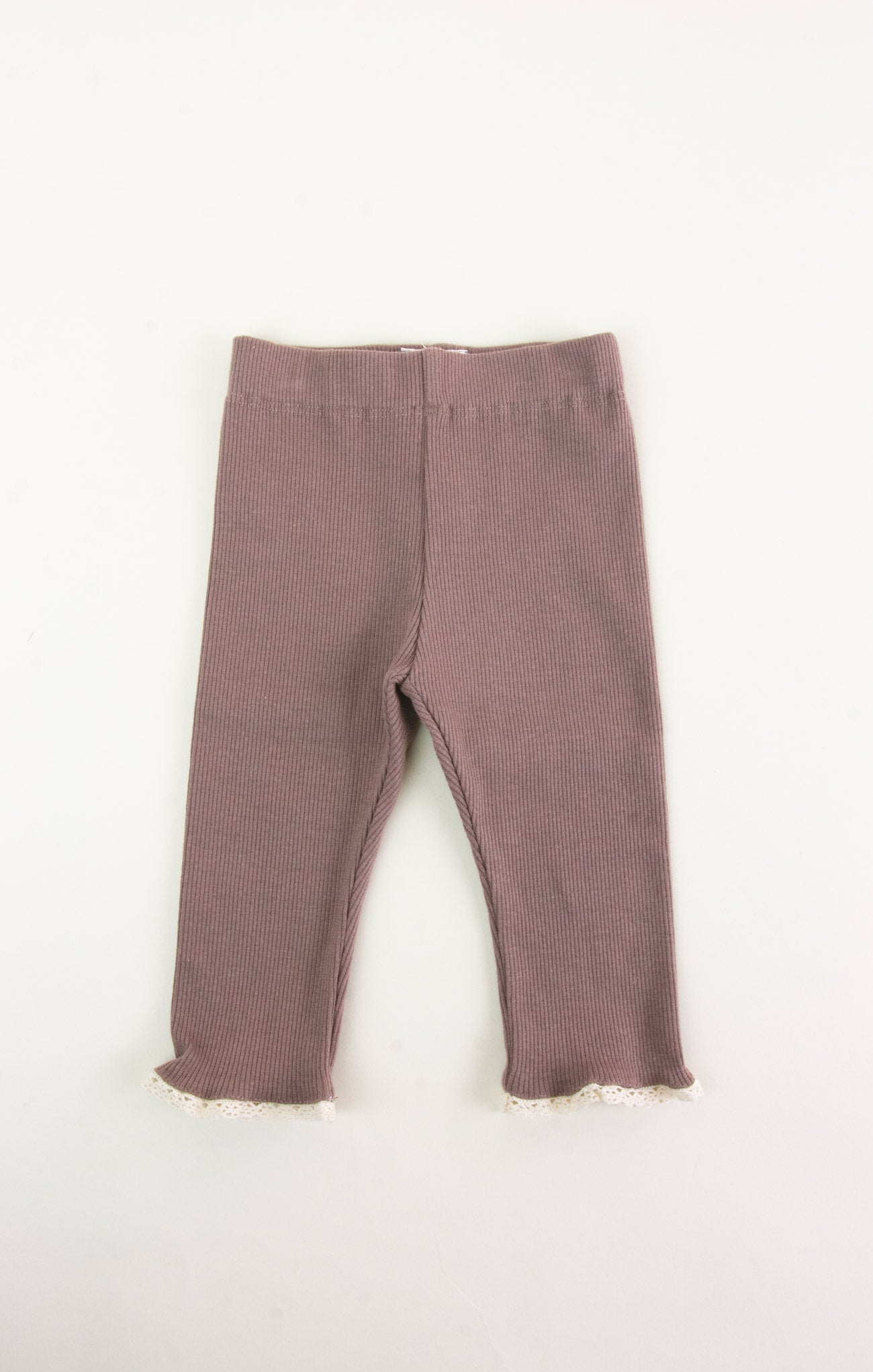 Pair of brown leggings with frayed hem on a white background