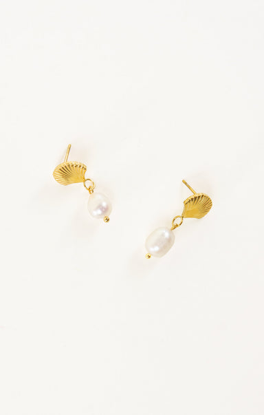 Gold earrings with pearl drops on a white background