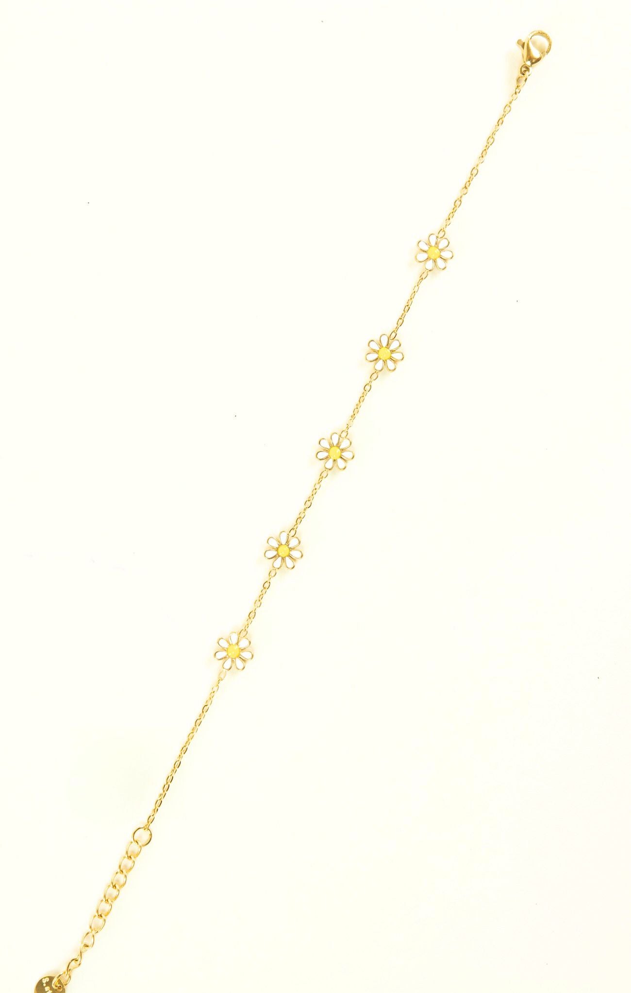 Gold anklet with floral designs on a white background
