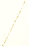 Gold anklet with floral designs on a white background