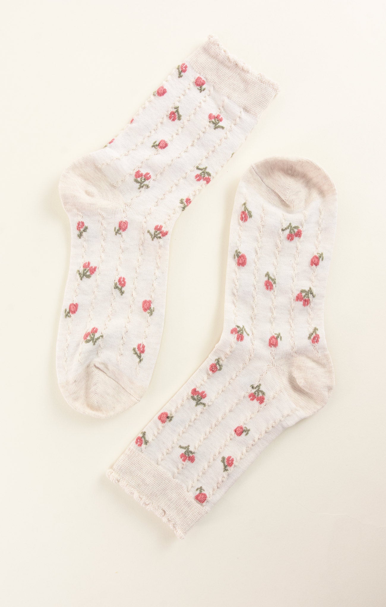 White socks with red floral patterns on a white background