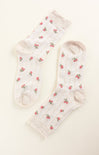 White socks with red floral patterns on a white background