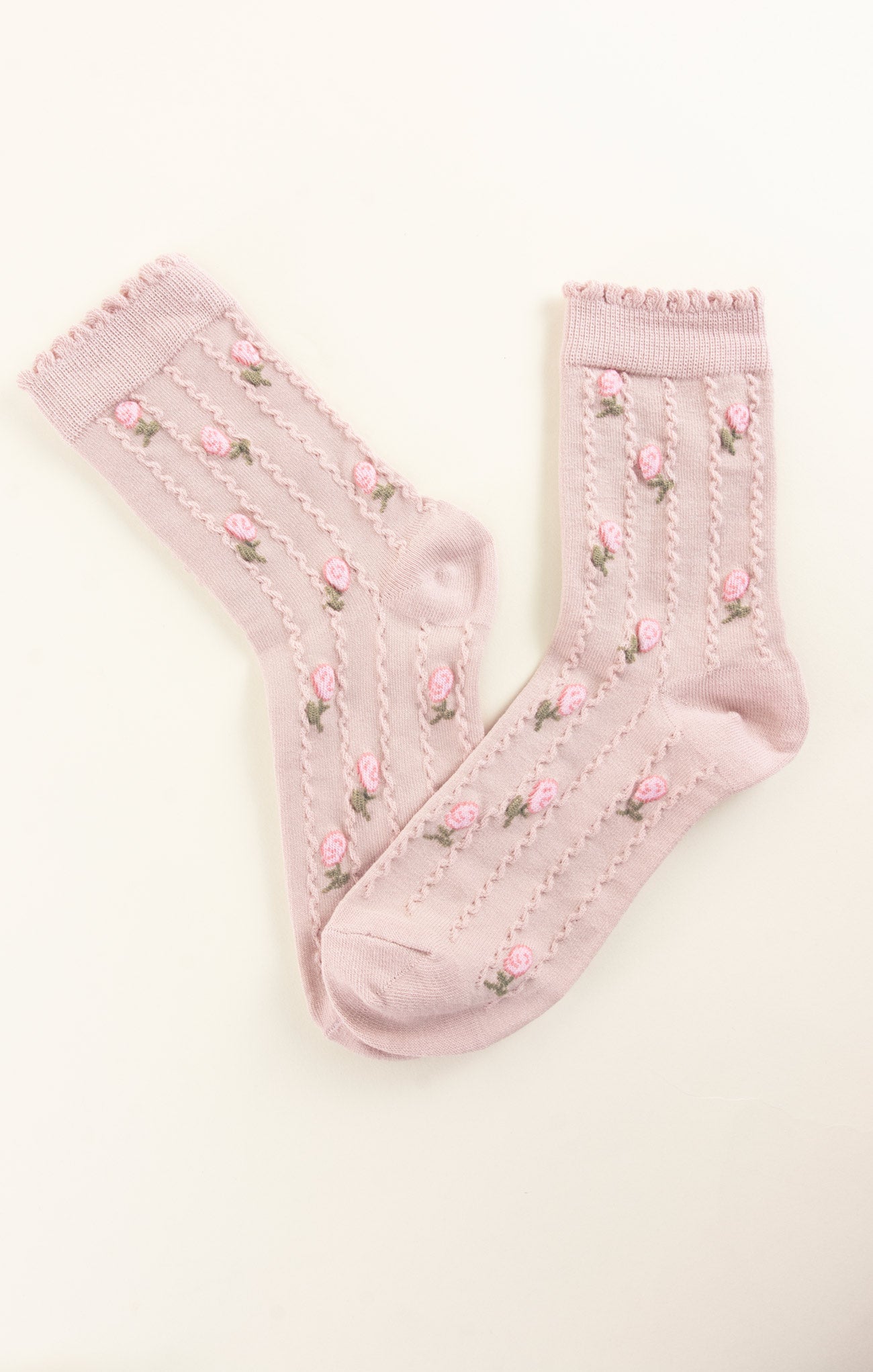 Pink socks with floral patterns on a white background