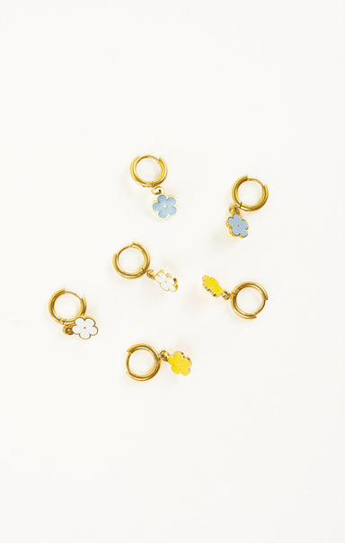 Set of gold earrings with floral designs on a white background