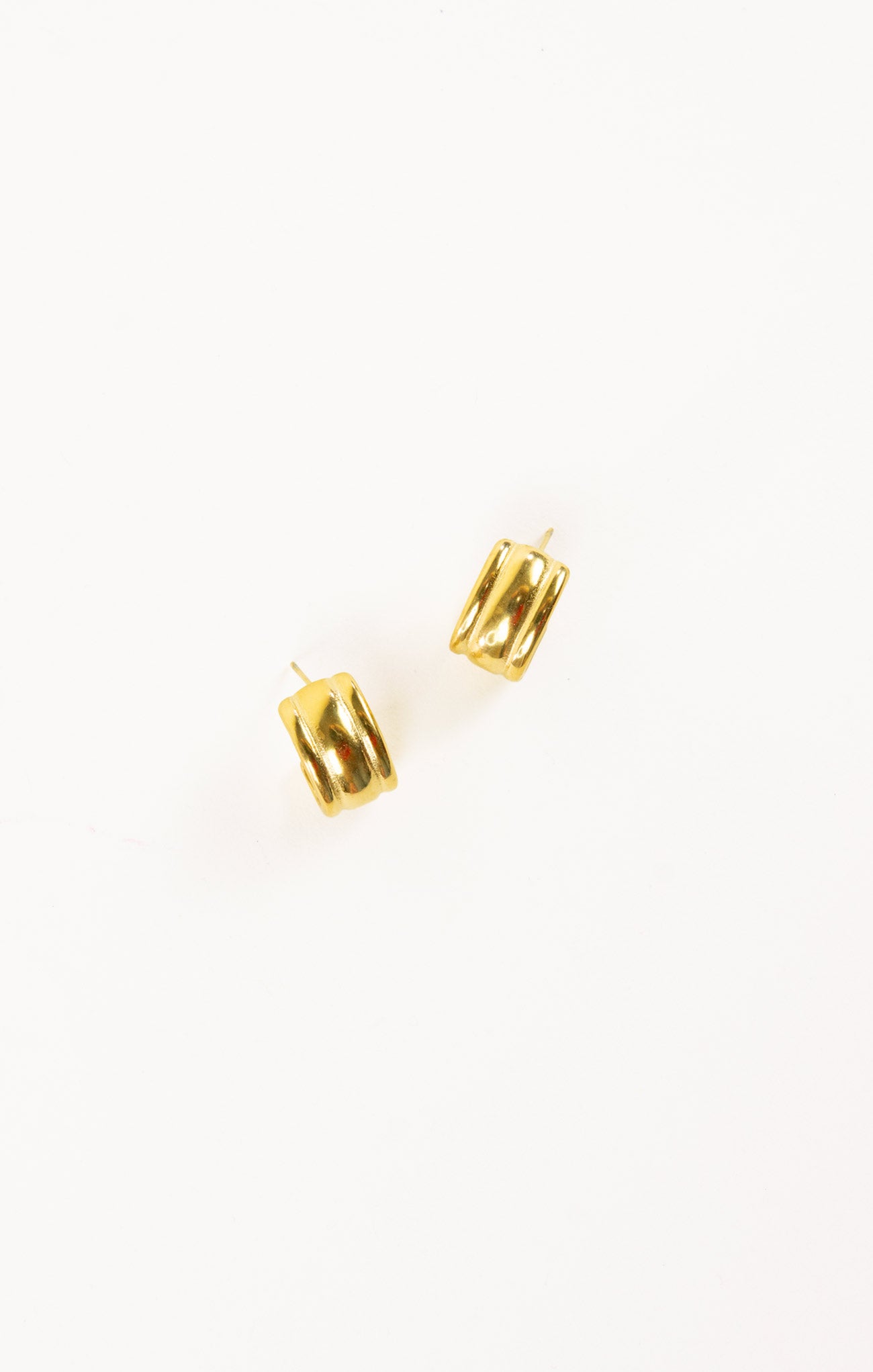 Two gold earrings on a white background