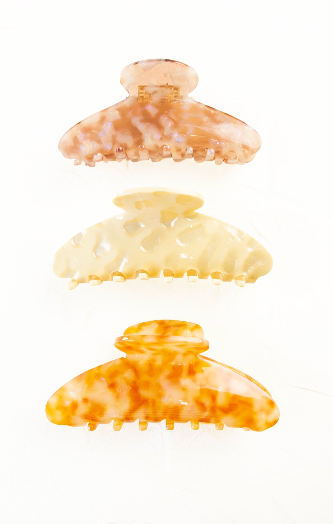 Three tortoiseshell patterned hair clips on a white background