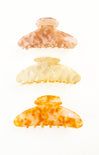 Three tortoiseshell patterned hair clips on a white background