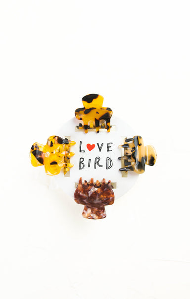 Set of tortoiseshell patterned earrings on a white background