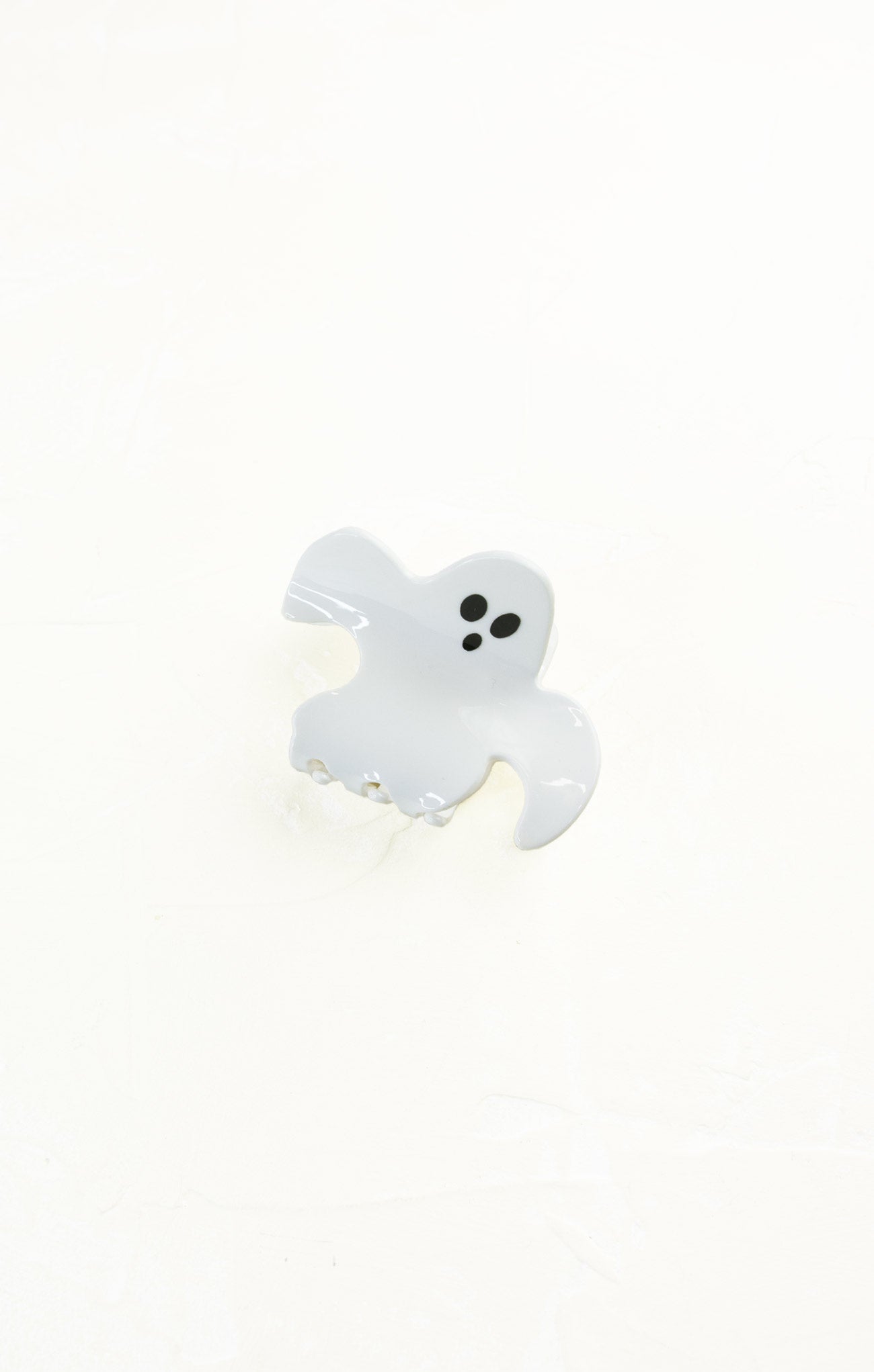White ghost-shaped object on a white background