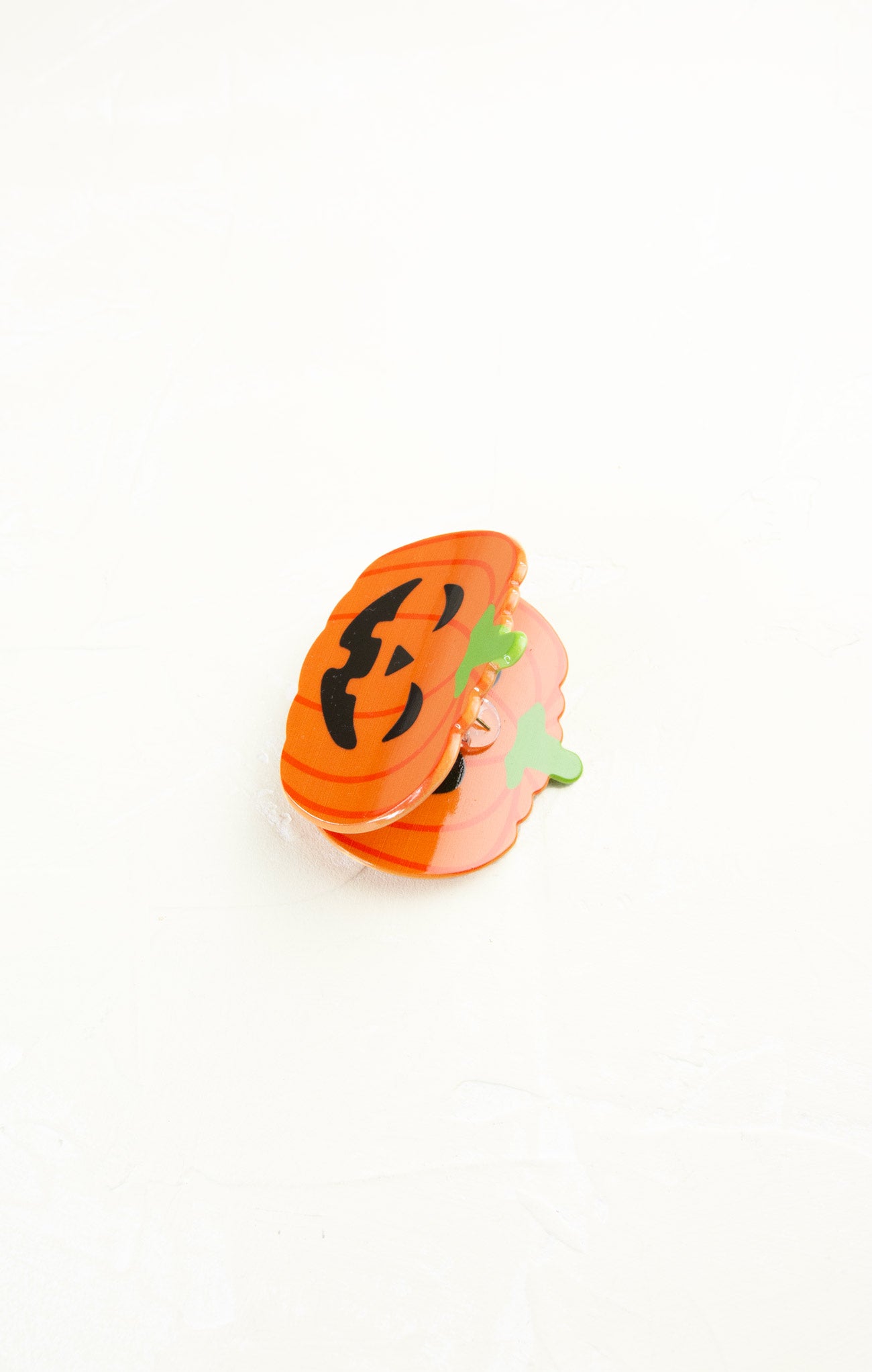 Stack of orange pumpkin-shaped cards on a white background