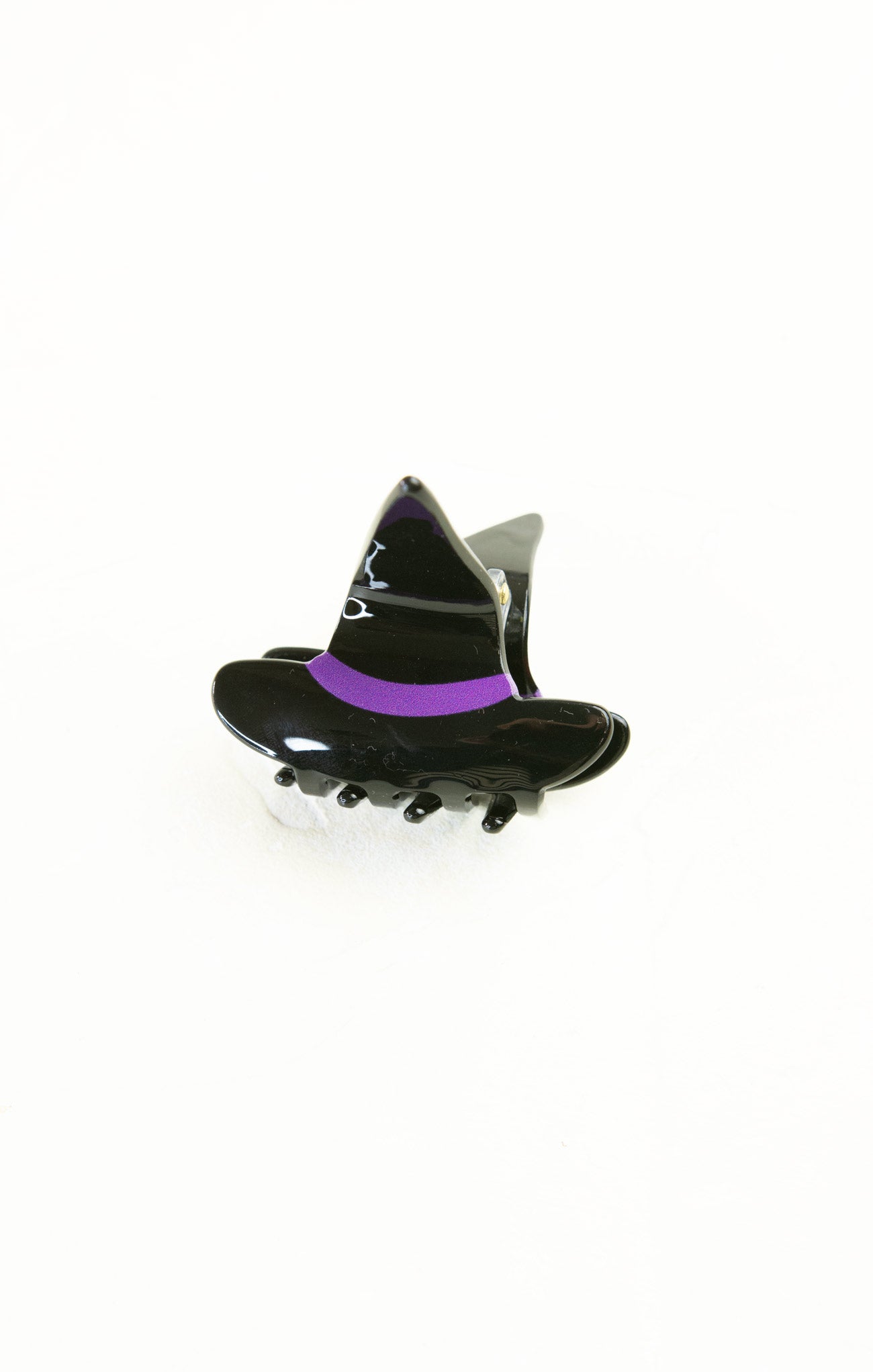 Black witch hat hair clip with purple band on a white background