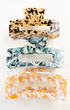 Three patterned hair clips stacked on a white background